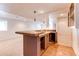 Finished basement wet bar featuring a tiled counter, decorative lighting, sink and cabinet at 10486 Cheetah Winds, Lone Tree, CO 80124