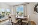 Elegant dining area filled with light and with outdoor view through glass patio doors at 42978 Colonial Trl, Elizabeth, CO 80107