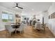 Bright dining area with views, showcasing open layout, wood floors, and contemporary lighting at 42978 Colonial Trl, Elizabeth, CO 80107