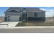 Charming home with modern garage door and gray accents, situated on a bright lot at 42978 Colonial Trl, Elizabeth, CO 80107