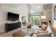 Bright living room with high ceilings, fireplace, large windows, and comfortable seating at 345 Fillmore # 407, Denver, CO 80206