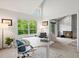 Bright home office with large window providing natural light, with a view to the living room with fireplace at 345 Fillmore # 407, Denver, CO 80206