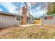 Backyard features a brick chimney, shed with American flag, and a small concrete patio at 8970 Garland Ct, Westminster, CO 80021
