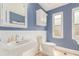 Traditional bathroom featuring a pedestal sink, toilet, and white paneled wall accents at 8970 Garland Ct, Westminster, CO 80021