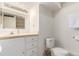 Bathroom with a white vanity, ample storage, and a toilet with neutral tile flooring at 8970 Garland Ct, Westminster, CO 80021