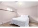 Cozy bedroom featuring a double bed with white bedding, carpeted flooring, and a small window at 8970 Garland Ct, Westminster, CO 80021