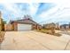 Property features attached two car garage, wide driveway, and welcoming neighborhood street at 8970 Garland Ct, Westminster, CO 80021