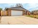 Attached two car garage with wide driveway, brick accents, and inviting curb appeal at 8970 Garland Ct, Westminster, CO 80021