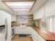 Bright kitchen features white cabinets, butcher block countertops, and stainless steel appliances at 8970 Garland Ct, Westminster, CO 80021