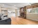 Bright living room featuring hardwood floors, a stone fireplace, and seamless flow to the kitchen at 8970 Garland Ct, Westminster, CO 80021