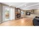 Inviting living room with hardwood floors, stone fireplace, and natural light from sliding glass door at 8970 Garland Ct, Westminster, CO 80021