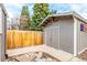 Backyard shed with double doors and a concrete patio, providing extra storage space at 8970 Garland Ct, Westminster, CO 80021