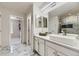 Bathroom featuring double sinks, modern fixtures, and glass enclosed shower with tile surround at 6108 S Harvest Ct, Aurora, CO 80016