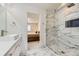 Bathroom featuring single sink and glass enclosed shower with tile surround at 6108 S Harvest Ct, Aurora, CO 80016