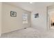 Empty bedroom with neutral walls, carpet, and a view to the yard through the window at 6108 S Harvest Ct, Aurora, CO 80016