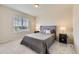 Neutral bedroom with a large window and a comfy queen-sized bed at 6108 S Harvest Ct, Aurora, CO 80016