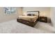 Carpeted bedroom featuring a king bed, side tables, and large window with blinds at 6108 S Harvest Ct, Aurora, CO 80016