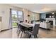 Open concept dining room with hardwood floors, natural light, and view to backyard at 6108 S Harvest Ct, Aurora, CO 80016