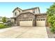 Charming two-story home featuring a stone facade and a spacious three-car garage at 6108 S Harvest Ct, Aurora, CO 80016