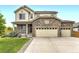 Charming two-story home featuring a stone facade and a spacious three-car garage at 6108 S Harvest Ct, Aurora, CO 80016