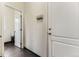 Hallway with white doors and black tile floor, adjacent to the powder room at 6108 S Harvest Ct, Aurora, CO 80016