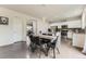 Open-concept kitchen with dining area and modern appliances, perfect for entertaining at 6108 S Harvest Ct, Aurora, CO 80016