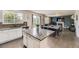 Bright kitchen featuring an island, stainless appliances, and seamless flow to the living area at 6108 S Harvest Ct, Aurora, CO 80016