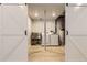 Well-equipped laundry room with modern machines and stylish barn doors at 6108 S Harvest Ct, Aurora, CO 80016