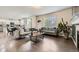 Open-concept living room with hardwood floors and plenty of natural light at 6108 S Harvest Ct, Aurora, CO 80016
