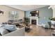 Cozy living room features a fireplace, large window, and stylish decor at 6108 S Harvest Ct, Aurora, CO 80016