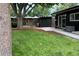 Large backyard with grassy area and mature trees at 1398 S Fairfax St, Denver, CO 80222