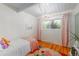 Light and airy bedroom with hardwood floors and a pink accent wall at 1398 S Fairfax St, Denver, CO 80222