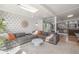 Bright living room, featuring a sectional sofa and stylish coffee table, open to kitchen at 1398 S Fairfax St, Denver, CO 80222