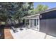 Concrete patio with seating area nestled amongst lush greenery at 1398 S Fairfax St, Denver, CO 80222