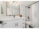 Modern bathroom with white vanity, black accents, and a bathtub at 1401 Jackson St # 204, Golden, CO 80401