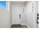 Bright entryway with modern white door and wood floors at 1401 Jackson St # 204, Golden, CO 80401