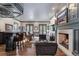 A basement bar with seating area features a fireplace and windows for natural light at 1350 E Greenwood Ln, Greenwood Village, CO 80121