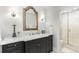 Elegant bathroom with decorative mirror, dark vanity, sconces, and a walk-in shower at 1350 E Greenwood Ln, Greenwood Village, CO 80121