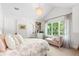 Bright bedroom with vaulted ceiling, white walls, a cozy chaise lounge, and a large window at 1350 E Greenwood Ln, Greenwood Village, CO 80121