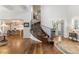 Spacious foyer with curved staircase, iron railings, hardwood floors, and elegant architectural details at 1350 E Greenwood Ln, Greenwood Village, CO 80121