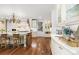 Elegant kitchen with marble countertops, custom white cabinetry, and a cozy breakfast bar at 1350 E Greenwood Ln, Greenwood Village, CO 80121