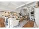 Open-concept living room features coffered ceilings, hardwood floors, and built-in shelving flanking the fireplace at 1350 E Greenwood Ln, Greenwood Village, CO 80121