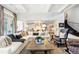 Bright living room shows hardwood floors, coffered ceilings, and an open-concept design with an open transition into the kitchen at 1350 E Greenwood Ln, Greenwood Village, CO 80121