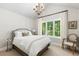 Bright main bedroom with large window, neutral walls and a charming chandelier fixture at 1350 E Greenwood Ln, Greenwood Village, CO 80121