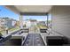 Spacious covered balcony with comfortable lounge seating and scenic neighborhood vistas at 12270 W 57Th Ave, Arvada, CO 80002