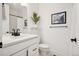 Bathroom with black fixtures, white vanity and subway tile shower, offering a sleek look at 12270 W 57Th Ave, Arvada, CO 80002