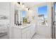 Bright bathroom features double sinks, a window, and a separate shower at 12270 W 57Th Ave, Arvada, CO 80002