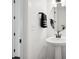 Clean, simple powder room with pedestal sink, round mirror, and modern fixtures at 12270 W 57Th Ave, Arvada, CO 80002