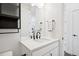 Stylish bathroom with a quartz countertop, matte black hardware, and decorative towels at 12270 W 57Th Ave, Arvada, CO 80002