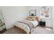 Cozy bedroom featuring neutral decor, a comfortable bed, a nightstand, and a window offering natural light at 12270 W 57Th Ave, Arvada, CO 80002